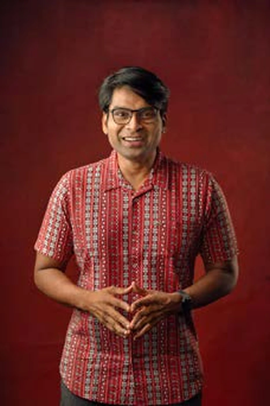 Portrait of Amar Ramesh wearing a patterned red shirt