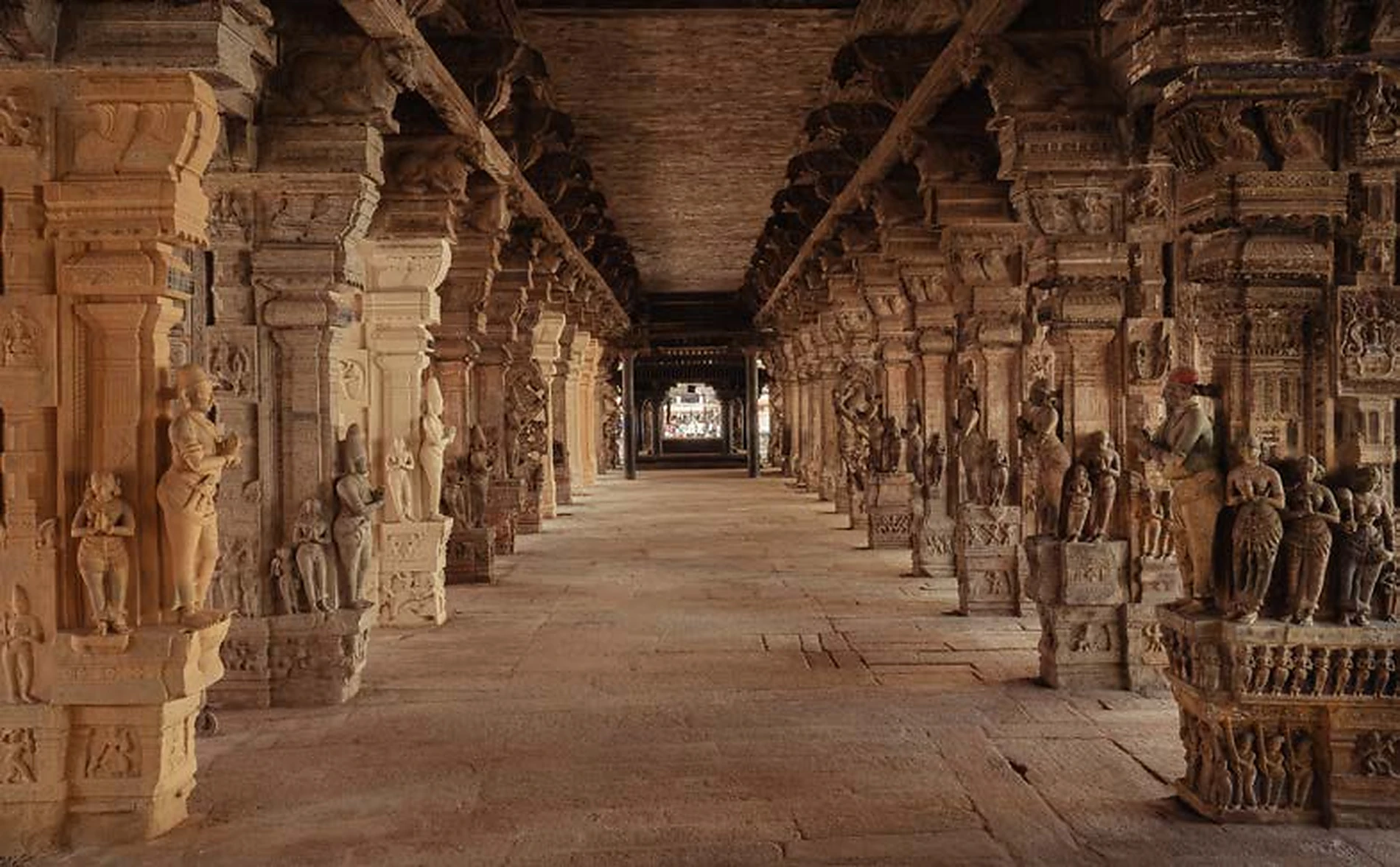 Long stone corridor lined with carved figures at Pudhu Mandapam