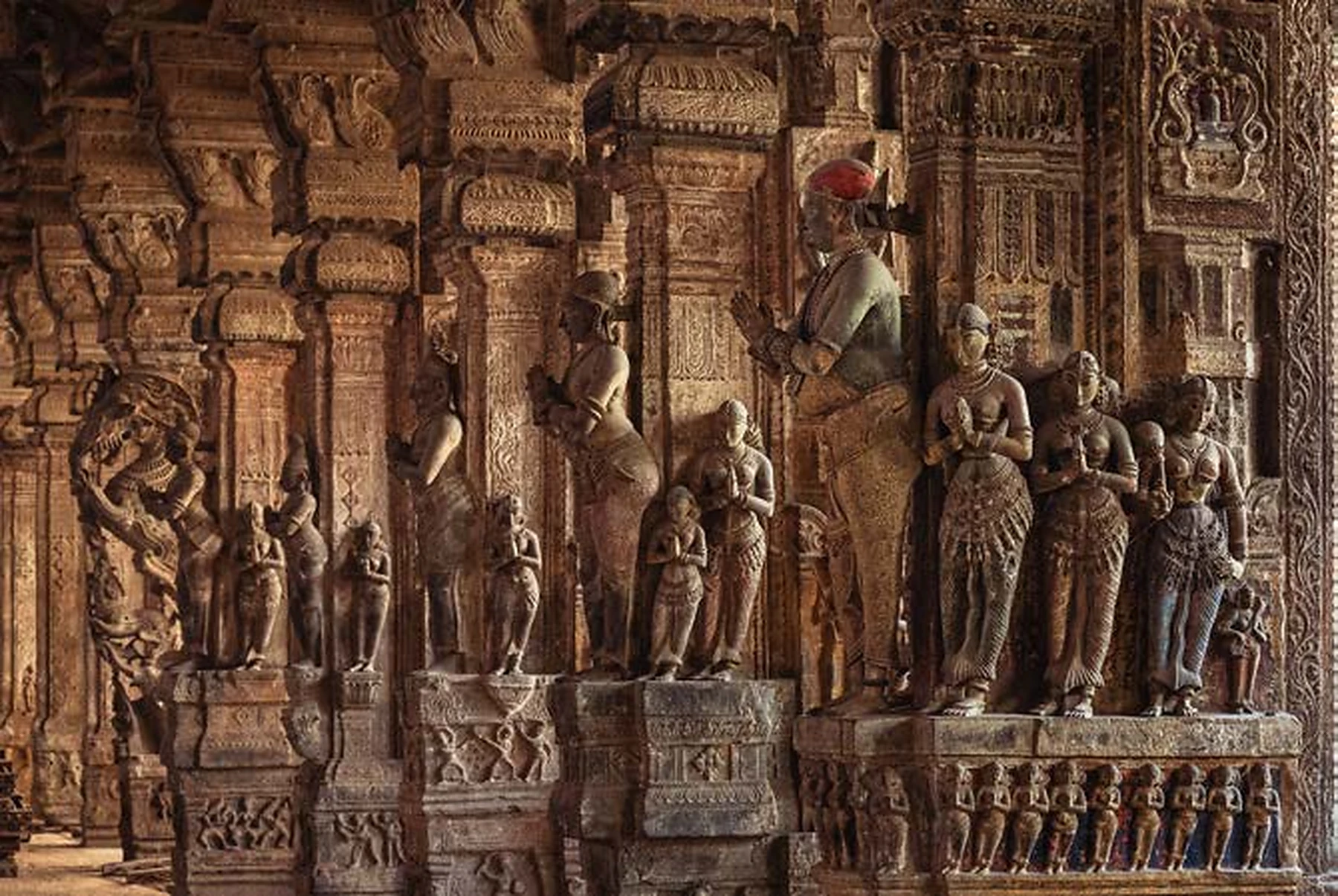 Detailed stone sculptures and pillars inside Pudhu Mandapam