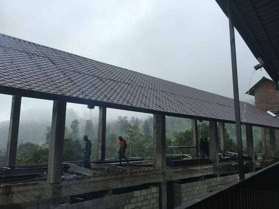 Construction workers building through the monsoon in Sri Lanka's tea country, 2016