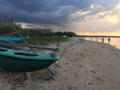 Outrigger fishing boats on the shore at dusk