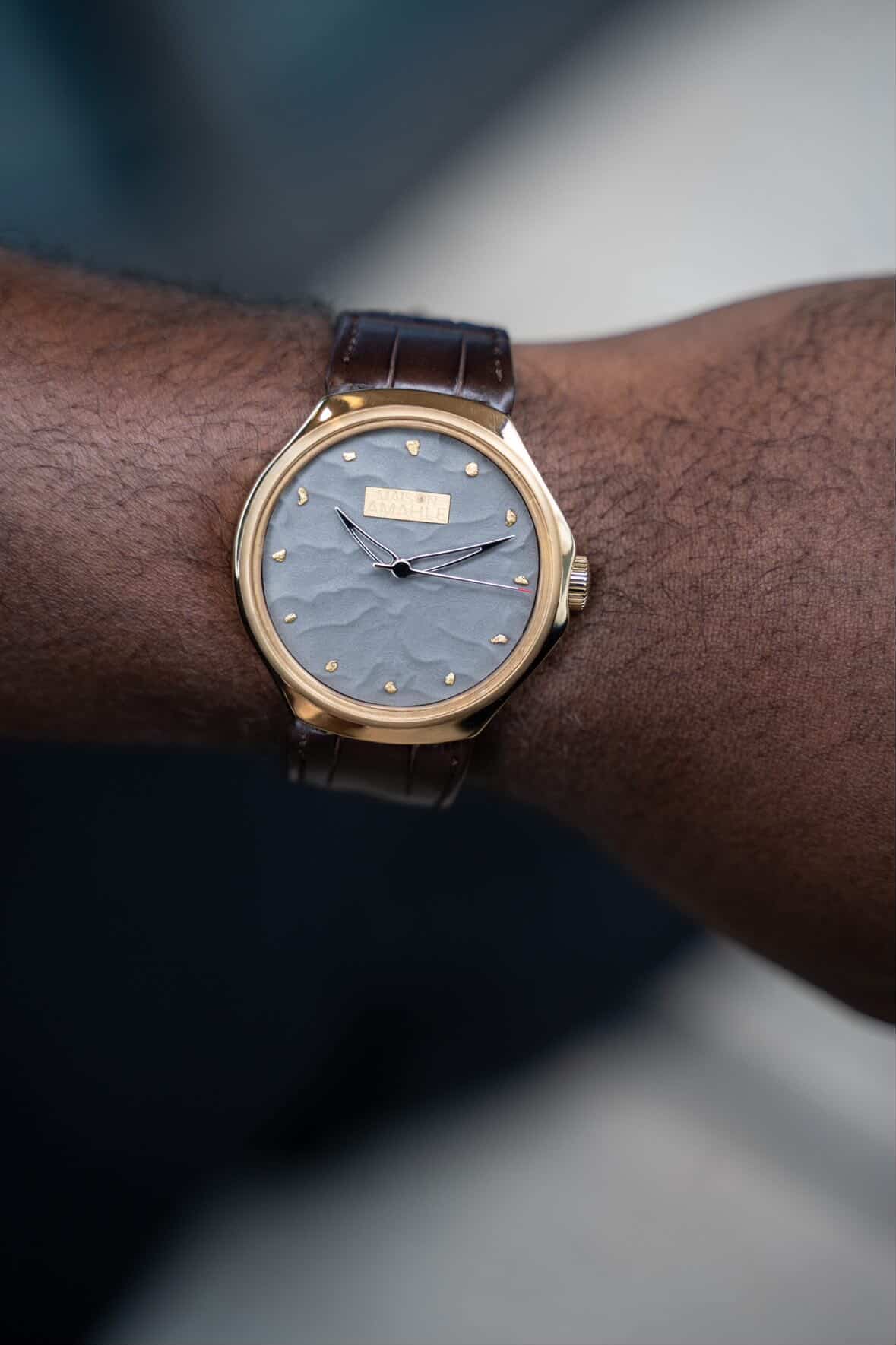The Zimbali 000 Midnight Desert worn on the wrist, its grey sand textured dial and hand set gold markers catching the light