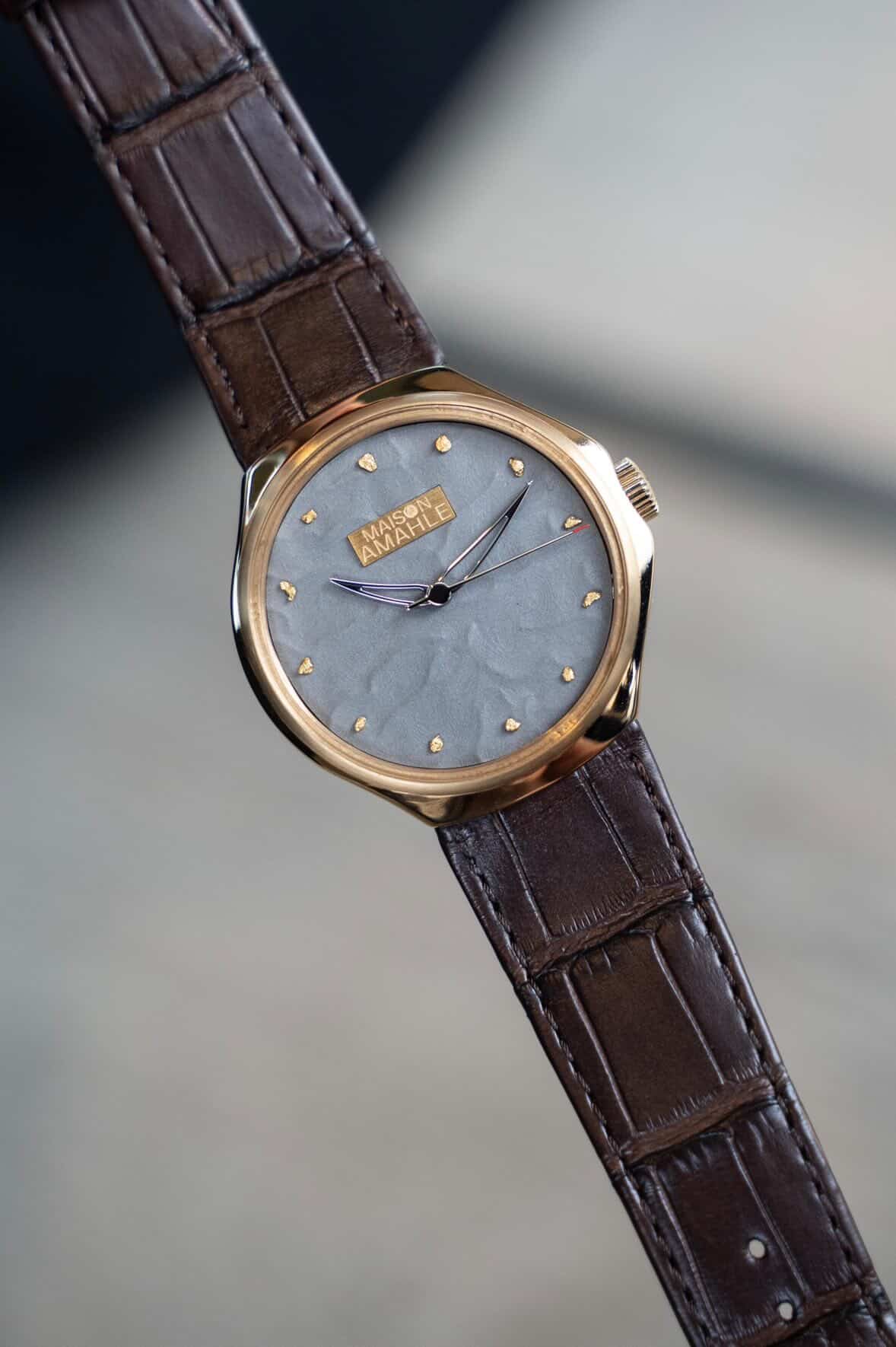 The Zimbali 000 Midnight Desert, a rose gold case with a grey sand textured dial and hand set gold markers, on a brown alligator strap
