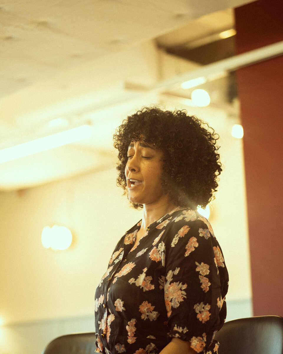Melanie speaking into a microphone during the conversation