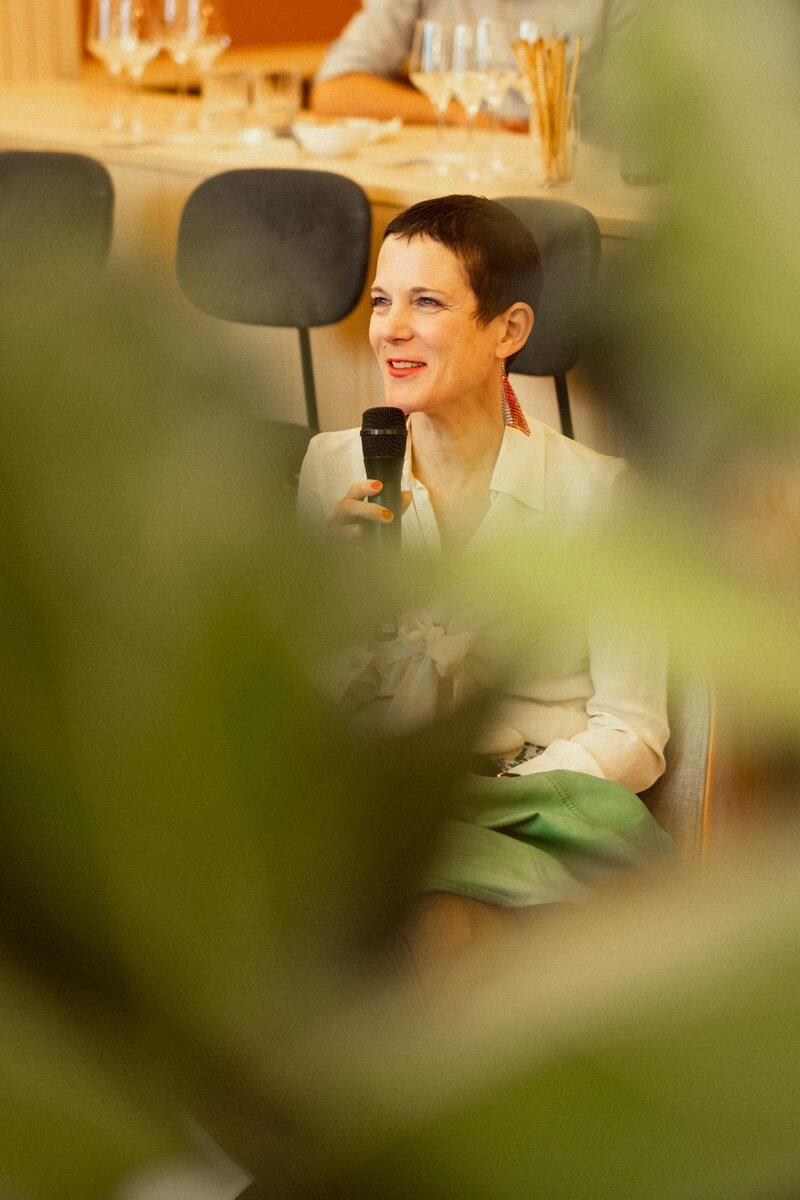 Catherine Hug smiling while answering a question from the audience